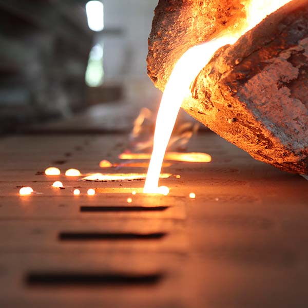 molten metal being poured into dies